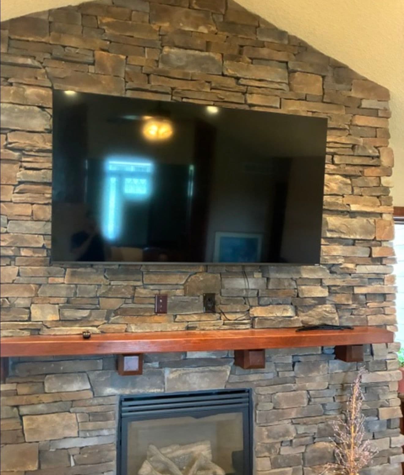 75-Inch TV Mounted on Real Stone Fireplace in Norwalk Iowa image