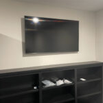 LED TV mounted and installed on the wall with table